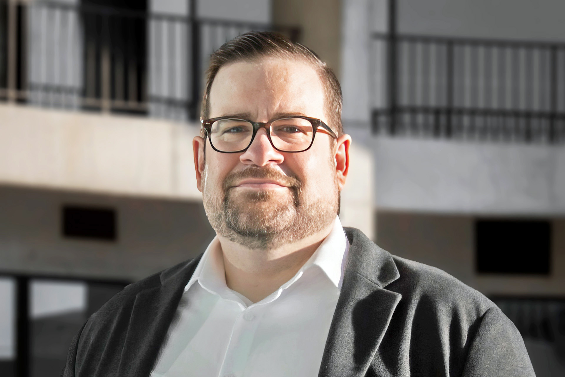 Headshot of Josh, Aggregate Studio Founder, with River City in the background