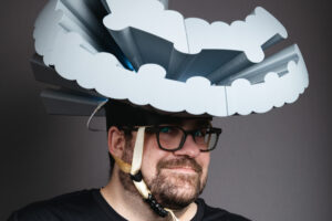 Josh dressed in black wearing a 3d printed interpretation of River City Apartments